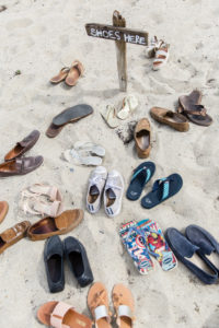 Guests leave their shoes on the sand as they head to one of the favorite beach locations on the Lower Cape.